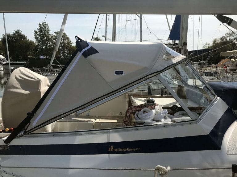 Hallberg 37 sprayhood recover by Tecsew, with a new stainless steel frame and hand-hold cut-outs.