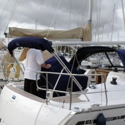 Close-up of a sailing yacht cockpit enclosure showcasing an integrated upgrade, such as a zip-in window or added grab handles for functionality and safety