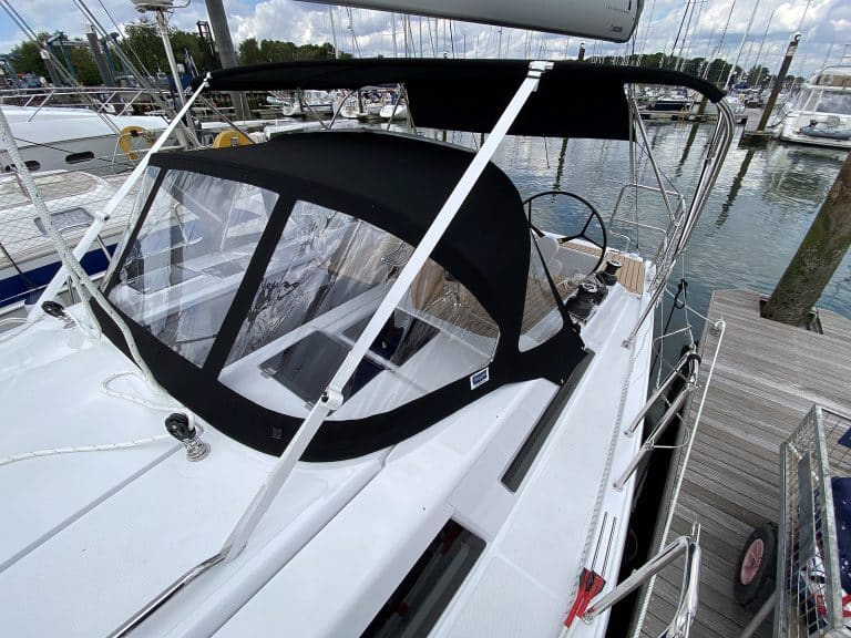 Hanse 348 bimini with Sunbrella fabric and polished stainless steel frame for UV protection.