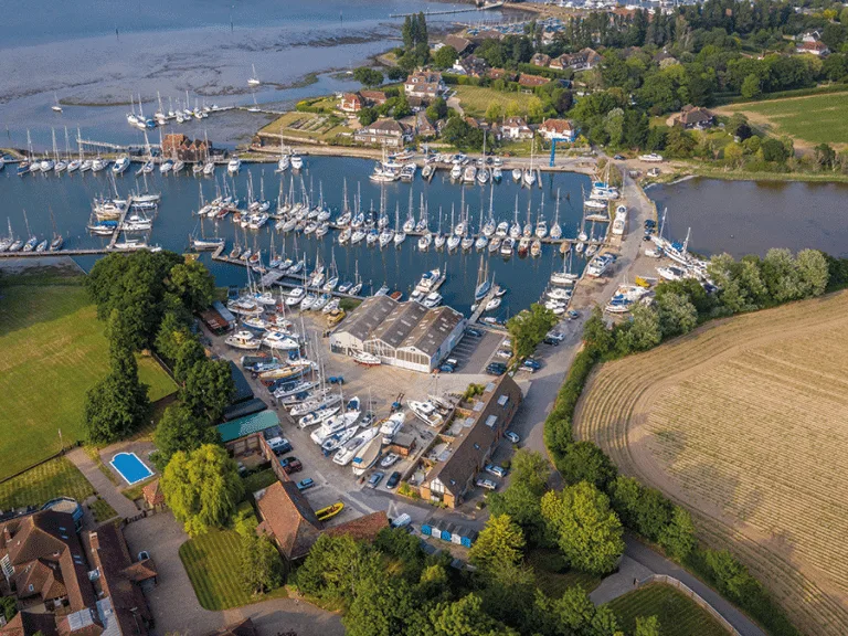 Scenic view of Birdham Pool Marina with boats docked and tranquil surroundings.
