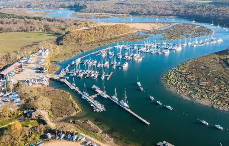 Buckler's Hard Marina in Beaulieu with boats docked by the historic village, showcasing Tecsew's custom boat covers and marine canvas products.