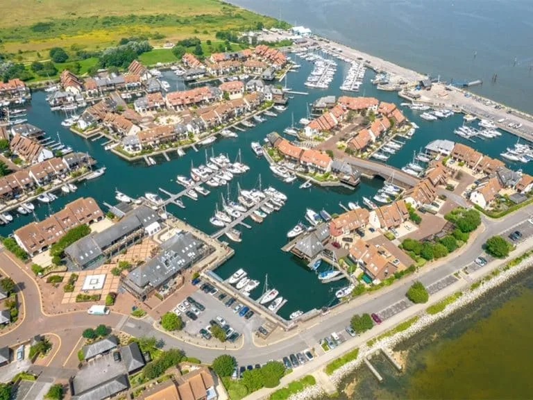 Hythe Marina Village in Southampton with boats docked along the waterfront, showcasing Tecsew's custom boat covers and marine canvas products.