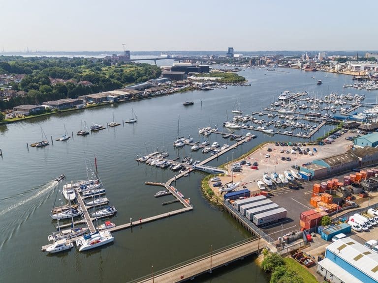 Shamrock Quay Marina in Southampton with boats docked and waterfront facilities, showcasing Tecsew's custom boat covers and marine canvas products.