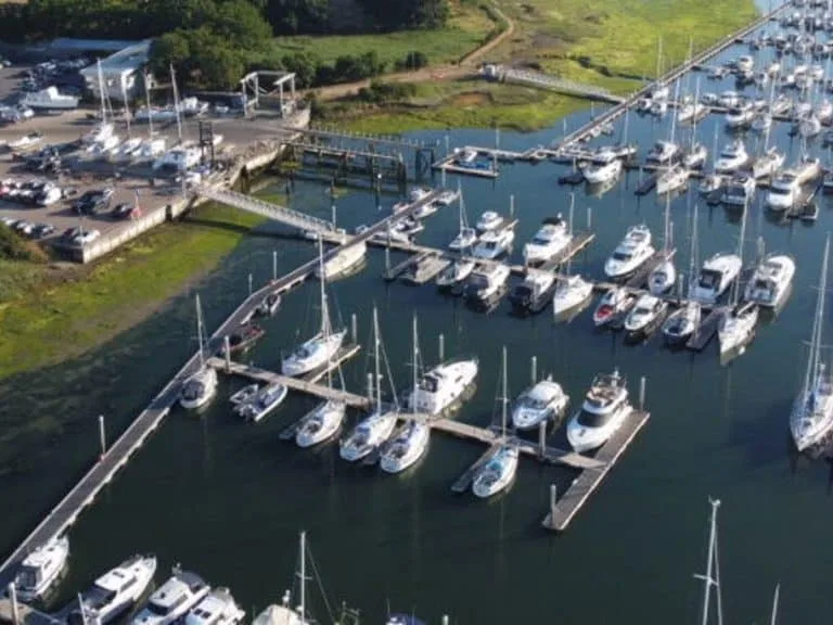 Scenic view of Universal Marina with sailboats and motorboats equipped with high-quality custom covers and marine canvas under a clear, sunny sky