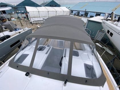 Hanse 410 cockpit enclosure with Sunbrella fabric, Renolit windows, and polished stainless steel frame