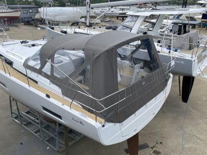 Hanse 410 cockpit enclosure with Sunbrella fabric, Renolit windows, and polished stainless steel frame