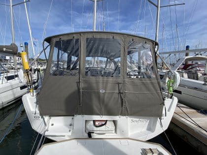 Dufour 41 with a fully installed bimini conversion-enclosure offering complete cockpit protection.