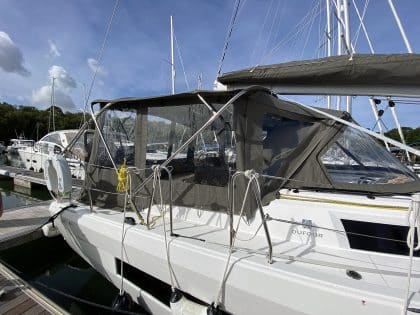 Dufour 41 with a fully installed bimini conversion-enclosure offering complete cockpit protection.