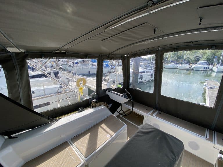 Dufour 41 with a fully installed bimini conversion-enclosure offering complete cockpit protection.