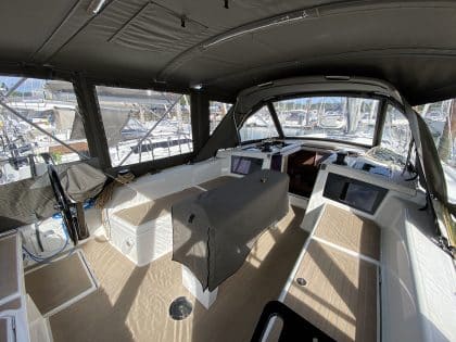 Dufour 41 with a fully installed bimini conversion-enclosure offering complete cockpit protection.