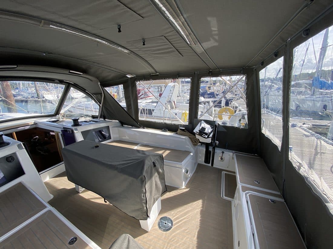 Dufour 41 with a fully installed bimini conversion-enclosure offering complete cockpit protection.