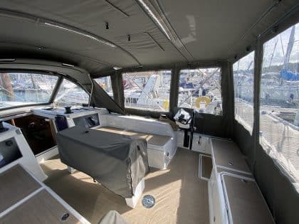 Dufour 41 with a fully installed bimini conversion-enclosure offering complete cockpit protection.