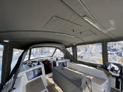 Dufour 41 with a fully installed bimini conversion-enclosure offering complete cockpit protection.