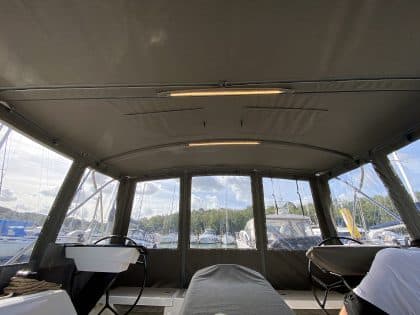 Dufour 41 with a fully installed bimini conversion-enclosure offering complete cockpit protection.