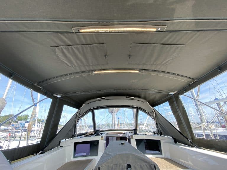 Dufour 41 with a fully installed bimini conversion-enclosure offering complete cockpit protection.