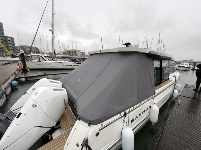 Saxdor 400 GTC aft cockpit covered with a custom-fit tonneau cover in Sunbrella fabric.