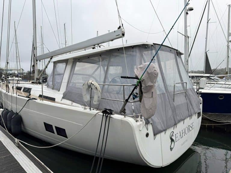 Hanse 588 HT cockpit enclosure integrated with the hard top and sunroof, providing full coverage aft of the support struts.