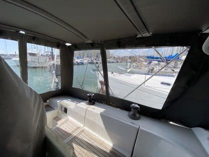 Hanse 400e bimini enclosure with Sunbrella fabric and clear windows, providing a fully enclosed cockpit.