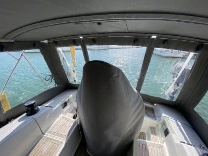 Hanse 400e bimini enclosure with Sunbrella fabric and clear windows, providing a fully enclosed cockpit.
