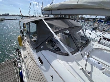 Hanse 400e bimini enclosure with Sunbrella fabric and clear windows, providing a fully enclosed cockpit.