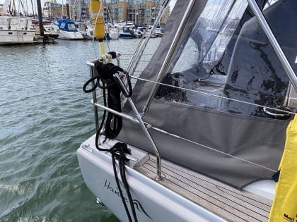 Hanse 400e bimini enclosure with Sunbrella fabric and clear windows, providing a fully enclosed cockpit.