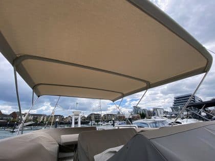 Sealine F42 bimini with a flat design, featuring Sunbrella fabric and stainless steel frame for shade and protection.