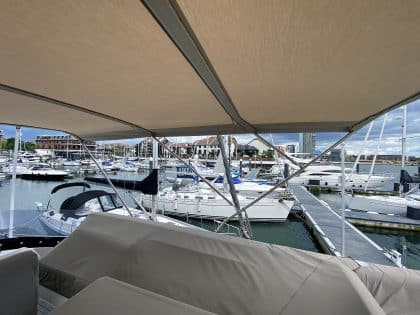Sealine F42 bimini with a flat design, featuring Sunbrella fabric and stainless steel frame for shade and protection.