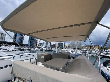 Sealine F42 bimini with a flat design, featuring Sunbrella fabric and stainless steel frame for shade and protection.