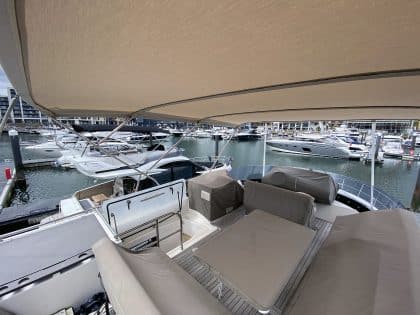 Sealine F42 bimini with a flat design, featuring Sunbrella fabric and stainless steel frame for shade and protection.