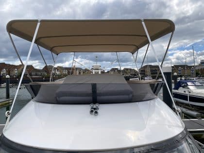 Sealine F42 bimini with a flat design, featuring Sunbrella fabric and stainless steel frame for shade and protection.