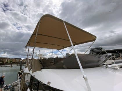 Sealine F42 bimini with a flat design, featuring Sunbrella fabric and stainless steel frame for shade and protection.