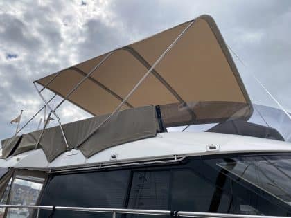 Sealine F42 bimini with a flat design, featuring Sunbrella fabric and stainless steel frame for shade and protection.