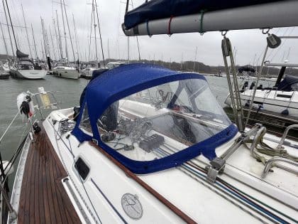 Sprayhood recover for Dufour 38 Classic, featuring Sunbrella fabric and crystal-clear windows for durability and visibility.