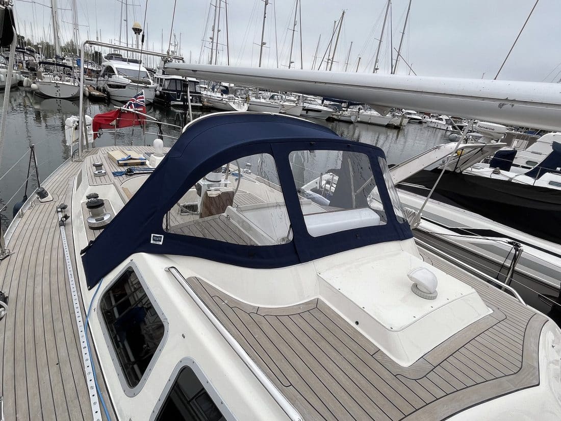 Custom sprayhood for Oyster 435 with stainless steel frame, Sunbrella fabric, and clear windows for durability and visibility.