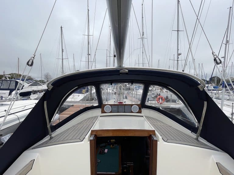Custom sprayhood for Oyster 435 with stainless steel frame, Sunbrella fabric, and clear windows for durability and visibility.