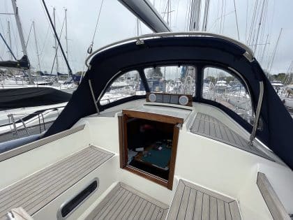Custom sprayhood for Oyster 435 with stainless steel frame, Sunbrella fabric, and clear windows for durability and visibility.
