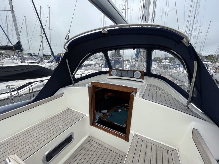 Custom sprayhood for Oyster 435 with stainless steel frame, Sunbrella fabric, and clear windows for durability and visibility.